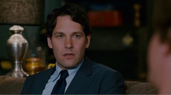 Movie still from “I Love You, Man” (2009), directed by John Hamburg – A man in a suit and tie sitting on a couch; Close Up shot, Over the shoulder angle