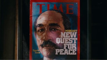 Movie still from “I Love You, Man” (2009), directed by John Hamburg – A time magazine cover with a picture of a man; Extreme Close Up shot, Overhead angle