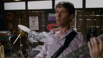 Movie still from “I Love You, Man” (2009), directed by John Hamburg – A man holding a guitar while standing next to a drum set; Close Up shot, Low angle