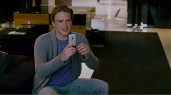 Movie still from “I Love You, Man” (2009), directed by John Hamburg – A man sitting on the ground holding a cell phone; Medium shot, Over the shoulder angle