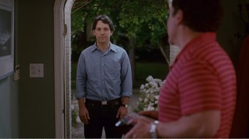 Movie still from “I Love You, Man” (2009), directed by John Hamburg – A man standing in front of another man holding a cell phone; Medium shot, Over the shoulder angle