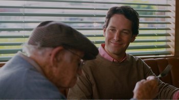 Movie still from “I Love You, Man” (2009), directed by John Hamburg – A man sitting next to another man at a table in front of a window; Close Up shot, Over the shoulder angle