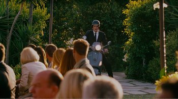 Movie still from “I Love You, Man” (2009), directed by John Hamburg – A man on a moped in front of a group of onlookers; Wide shot, Over the shoulder angle