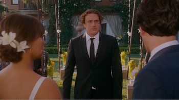 Movie still from “I Love You, Man” (2009), directed by John Hamburg – A man in a suit and tie standing in front of a swing; Medium shot, Over the shoulder angle