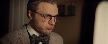 Movie still from “I Origins” (2014), directed by Mike Cahill – A person wearing glasses and a bow tie; Close Up shot, Low angle