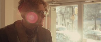 Movie still from “I Origins” (2014), directed by Mike Cahill – A man wearing glasses looking out of a window; Close Up shot, Over the shoulder angle