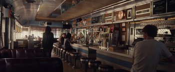Movie still from “I Origins” (2014), directed by Mike Cahill – People sitting at a counter in a restaurant; Wide shot, High angle