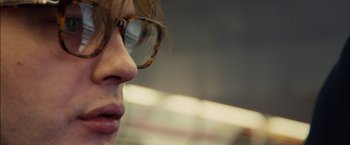 Movie still from “I Origins” (2014), directed by Mike Cahill – A person wearing glasses; Extreme Close Up shot, Over the shoulder angle