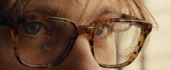Movie still from “I Origins” (2014), directed by Mike Cahill – A person wearing glasses; Extreme Close Up shot, Over the shoulder angle