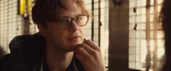 Movie still from “I Origins” (2014), directed by Mike Cahill – A person wearing glasses; Close Up shot, Over the shoulder angle