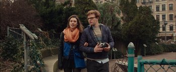 Movie still from “I Origins” (2014), directed by Mike Cahill – A man and a woman standing next to each other holding a camera; Medium shot, Over the shoulder angle