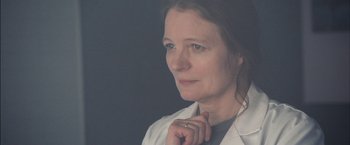 Movie still from “I Origins” (2014), directed by Mike Cahill – A person wearing a white shirt; Close Up shot, Over the shoulder angle