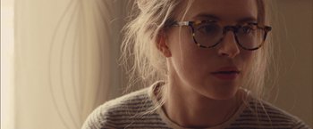 Movie still from “I Origins” (2014), directed by Mike Cahill – A person wearing glasses; Close Up shot, Over the shoulder angle