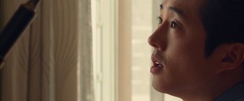 Movie still from “I Origins” (2014), directed by Mike Cahill – A person's face in front of a window; Close Up shot, Over the shoulder angle