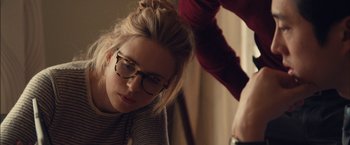 Movie still from “I Origins” (2014), directed by Mike Cahill – A woman with glasses is sitting in front of a laptop; Close Up shot, Over the shoulder angle