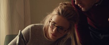 Movie still from “I Origins” (2014), directed by Mike Cahill – A woman with glasses is looking down at the floor; Close Up shot, Over the shoulder angle