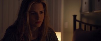 Movie still from “I Origins” (2014), directed by Mike Cahill – A beautiful young lady sitting in front of a window; Close Up shot, Over the shoulder angle