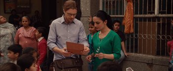 Movie still from “I Origins” (2014), directed by Mike Cahill – A man and a woman looking at an electronic device; Medium shot, Over the shoulder angle