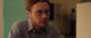 Movie still from “I Origins” (2014), directed by Mike Cahill – A person wearing glasses; Close Up shot, Over the shoulder angle