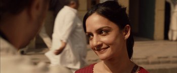 Movie still from “I Origins” (2014), directed by Mike Cahill – A person smiling for the camera; Close Up shot, Over the shoulder angle