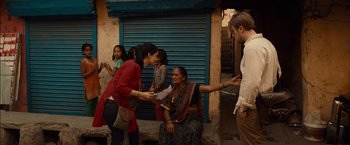 Movie still from “I Origins” (2014), directed by Mike Cahill – A group of people standing on the side of the street; Medium shot, Over the shoulder angle