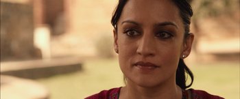 Movie still from “I Origins” (2014), directed by Mike Cahill – A woman's face in a red shirt; Close Up shot, Over the shoulder angle