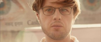 Movie still from “I Origins” (2014), directed by Mike Cahill – A person wearing glasses; Close Up shot, Low angle