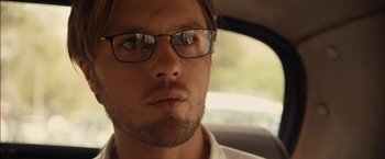 Movie still from “I Origins” (2014), directed by Mike Cahill – A person wearing glasses in a car; Close Up shot, Low angle