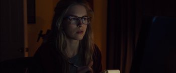 Movie still from “I Origins” (2014), directed by Mike Cahill – A woman with glasses is holding a pen in her hand; Close Up shot, Over the shoulder angle