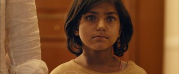 A young girl is looking into the camera