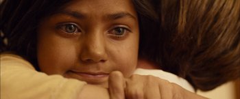 Movie still from “I Origins” (2014), directed by Mike Cahill – A young girl's face with her hand on her chin; Extreme Close Up shot, Overhead angle