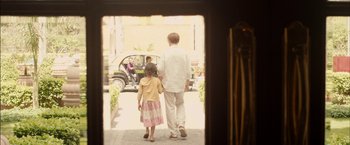 Movie still from “I Origins” (2014), directed by Mike Cahill – A man and a little girl walking down a sidewalk; Wide shot, Over the shoulder angle