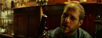 Movie still from “I Stand Alone” (1998), directed by Gaspar Noé – A man holding a gun in his hand; Close Up shot, Low angle