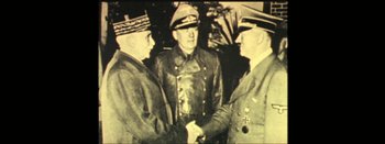 Movie still from “I Stand Alone” (1998), directed by Gaspar Noé – A black and white photo of three men shaking hands; Medium shot, High angle