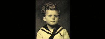 Movie still from “I Stand Alone” (1998), directed by Gaspar Noé – An old black and white photo of a boy in a sailor suit; Extreme Close Up shot, High angle
