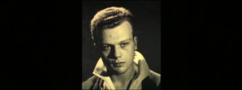 Movie still from “I Stand Alone” (1998), directed by Gaspar Noé – An old black and white photo of a young man; Close Up shot, Low angle