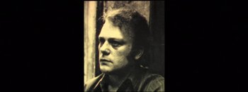 Movie still from “I Stand Alone” (1998), directed by Gaspar Noé – An old photo of a man looking at the camera; Close Up shot, High angle