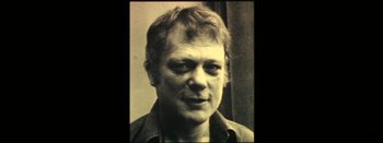 Movie still from “I Stand Alone” (1998), directed by Gaspar Noé – An old photo of an older man with a beard; Close Up shot, Low angle