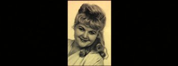 Movie still from “I Stand Alone” (1998), directed by Gaspar Noé – An old photo of a woman smiling for the camera; Extreme Close Up shot, High angle