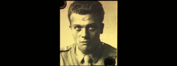 Movie still from “I Stand Alone” (1998), directed by Gaspar Noé – An old photo of a man wearing a military uniform; Close Up shot, Overhead angle