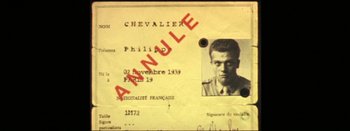 Movie still from “I Stand Alone” (1998), directed by Gaspar Noé – An old photo of a man with the name philip chevalier on it; Extreme Close Up shot, Overhead angle
