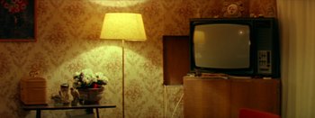 Movie still from “I Stand Alone” (1998), directed by Gaspar Noé – A television and a lamp in a room; Medium shot, High angle