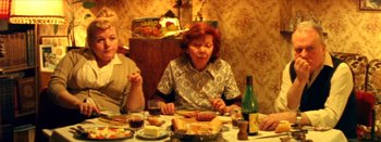 Movie still from “I Stand Alone” (1998), directed by Gaspar Noé – A woman sitting at a dinner table with a plate in front of her; Medium shot, High angle