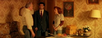 Movie still from “I Stand Alone” (1998), directed by Gaspar Noé – A group of people standing around a table; Medium shot, High angle