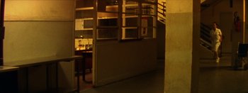 Movie still from “I Stand Alone” (1998), directed by Gaspar Noé – A view of a room with a desk in the corner; Wide shot, High angle