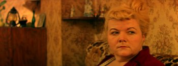 Movie still from “I Stand Alone” (1998), directed by Gaspar Noé – A person wearing a red shirt; Close Up shot, High angle