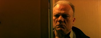 Movie still from “I Stand Alone” (1998), directed by Gaspar Noé – An older man looking into a bathroom mirror; Close Up shot, Low angle