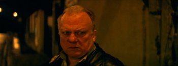 Movie still from “I Stand Alone” (1998), directed by Gaspar Noé – An older man wearing a leather jacket looking at the camera; Close Up shot, High angle