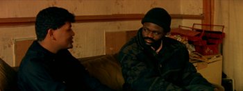 Movie still from “I Stand Alone” (1998), directed by Gaspar Noé – A man sitting on top of a couch in a living room; Medium shot, High angle