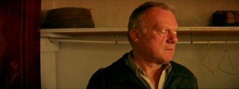 Movie still from “I Stand Alone” (1998), directed by Gaspar Noé – An older man is looking into the distance; Close Up shot, Over the shoulder angle